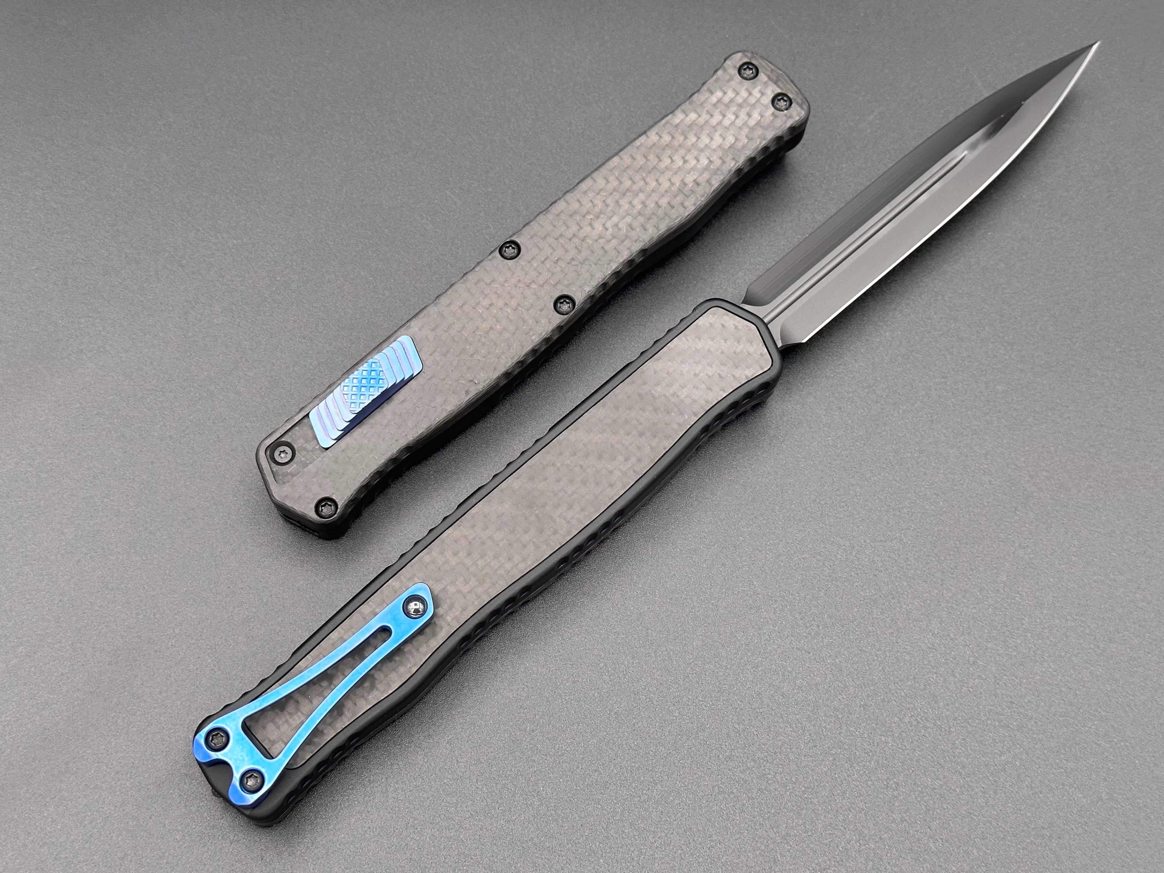 Heretic Knives Cleric II Carbon Fiber top/CF Inlay, DLC Double Edge, black hardware, and Blue Ti Clip and Button - Tristar Edge